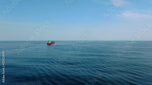 Large cargo ship. A bulk carrier carries cargo across the ocean. Transportation. Delivery. Logistics. A large ship for transporting. Aerial 4k shot.