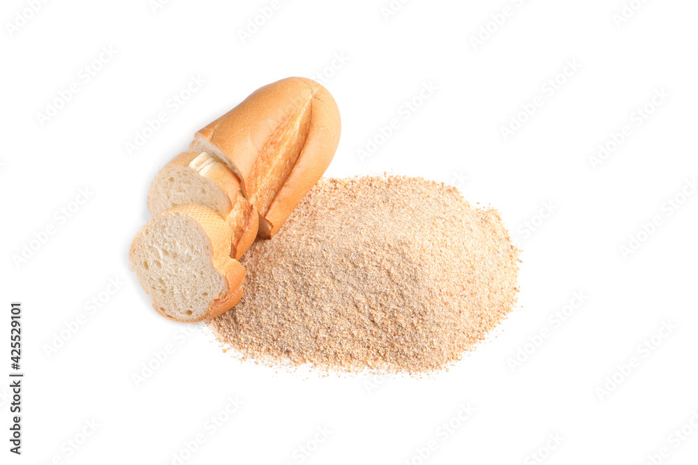 Pile of fresh bread crumbs and sliced loaf on white background, above view Pile of fresh bread crumbs and sliced loaf on white background, above view