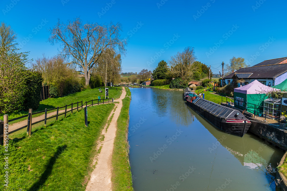 Fototapeta premium A view across the canal basin and locks on the Oxford Canal at Hillmorton, Warwickshire, UK on a bright Spring day