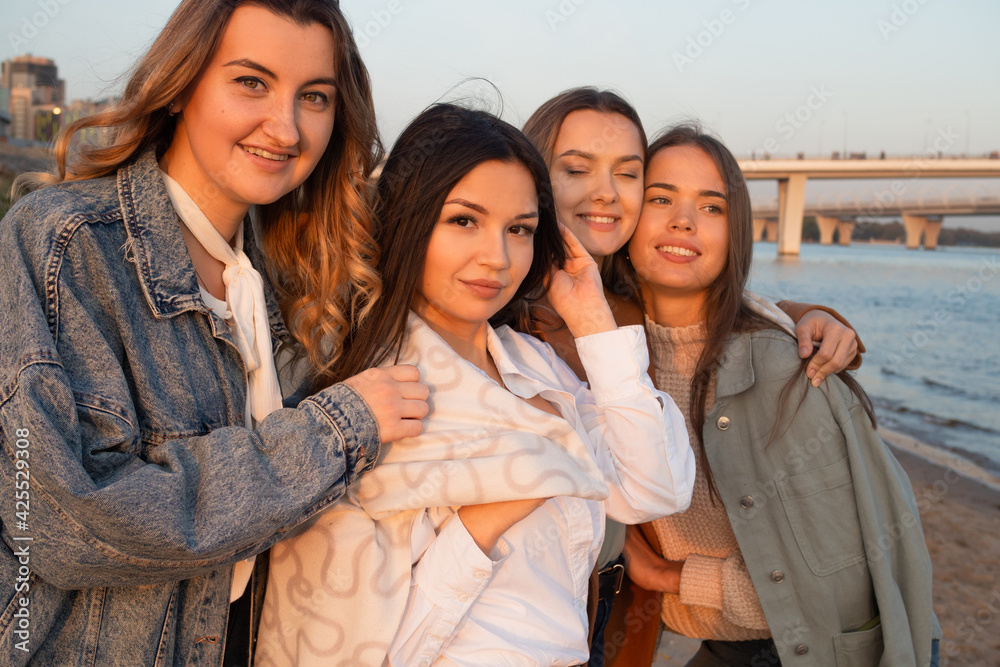 Group of friends having fun on the beach, meeting friends. Young women Group of friends having fun on the beach, meeting friends. Young women
