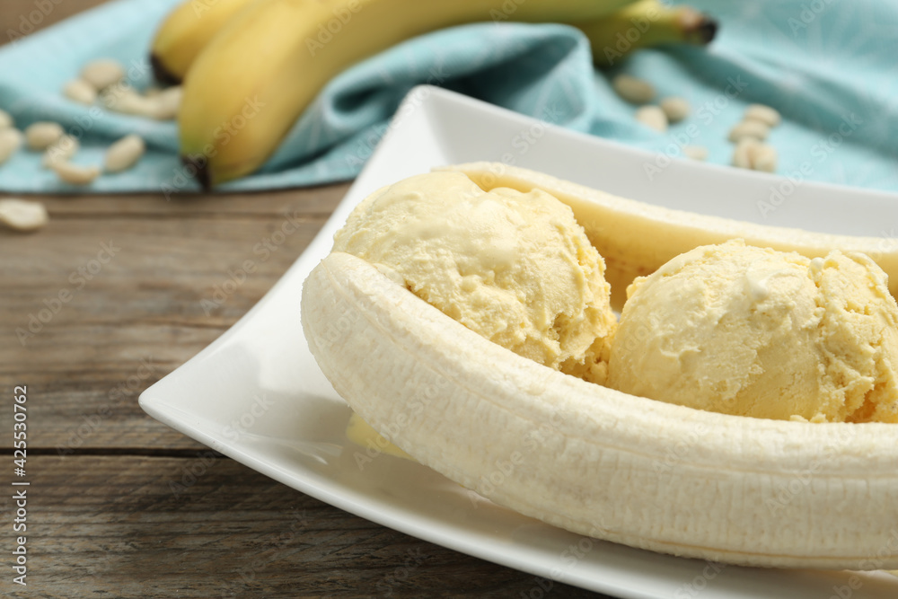 Delicious banana split ice cream on wooden table, closeup Delicious banana split ice cream on wooden table, closeup