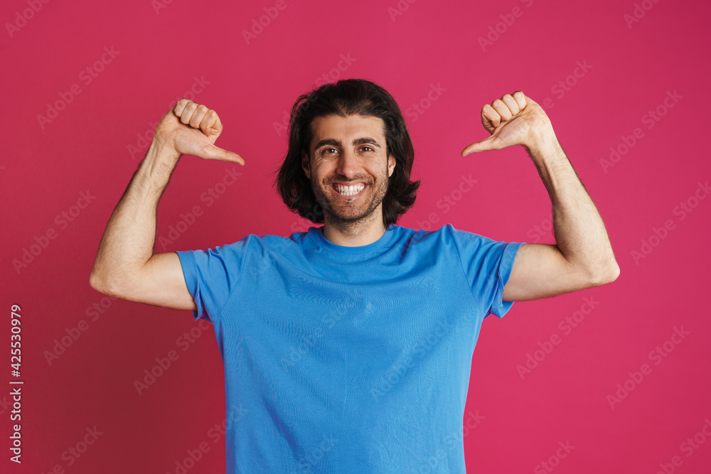 Unshaven brunette man smiling and pointing finger at himself Unshaven brunette man smiling and pointing finger at himself