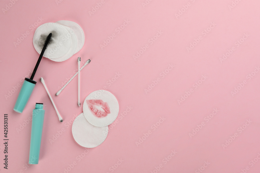 Clean and dirty cotton pads, swabs with mascara on light pink background, flat lay. Space for text Clean and dirty cotton pads, swabs with mascara on light pink background, flat lay. Space for text