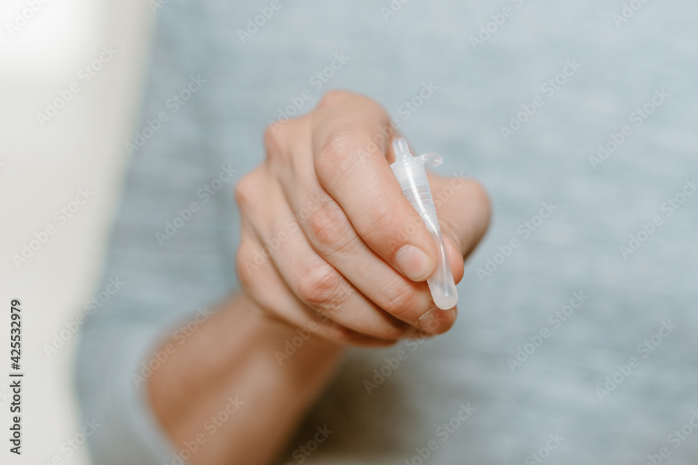 custom made wallpaper toronto digitalLateral-Flow-Test covid rapid home-use test kit for saliva - step 3 - squeeze and shake plastic tube