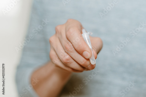 Wallpaper Mural Lateral-Flow-Test covid rapid home-use test kit for saliva - step 3 - squeeze and shake plastic tube Torontodigital.ca