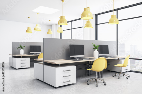 Bright empty coworking space with computers, yellow chairs, big windows, white concrete floor and ceiling, work space interior concept. 3d rendering