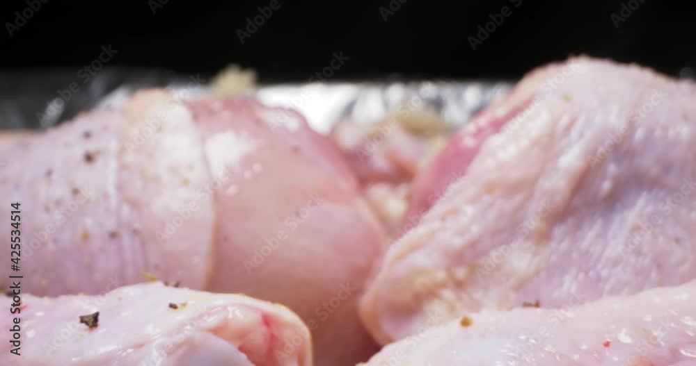 detailed extreme close-up of the process of cooking spiced chicken legs in foil. detailed extreme close-up of the process of cooking spiced chicken legs in foil.
