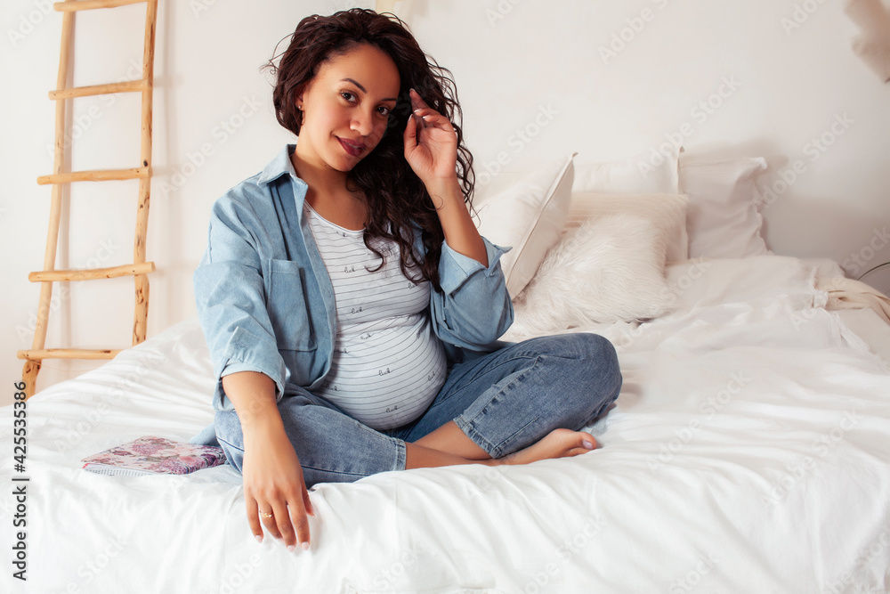 young pretty african american woman pregnant laying in bed, lifestyle people concept young pretty african american woman pregnant laying in bed, lifestyle people concept