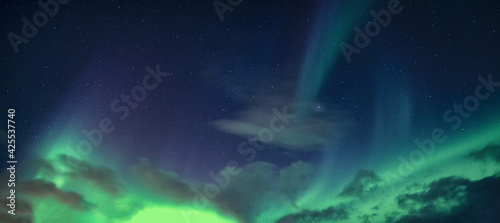 Aurora Borealis or Northern Lights with starry glowing in the night sky © Mumemories
