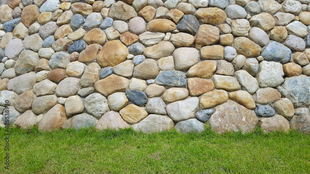 Fototapeta premium rock wall background with green grass