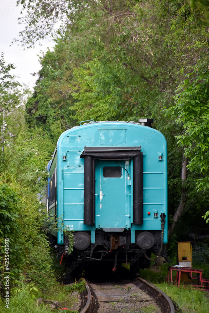 The departing train, the last blue car of the outgoing train from the railway station