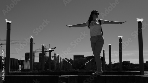 Black and white photo of a girl in front of a destroyed sports complex in Talin photo