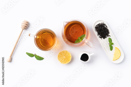 Design concept top view of honey black tea with lemon and mint.