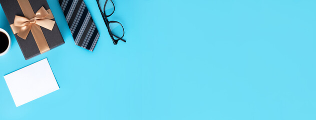 Design concept top view of Father's day gift idea with greeting on blue background.