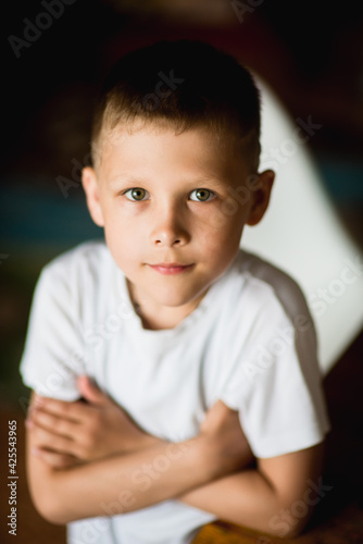 emotional, cheerful portrait of a boy on a dark background, selective focus