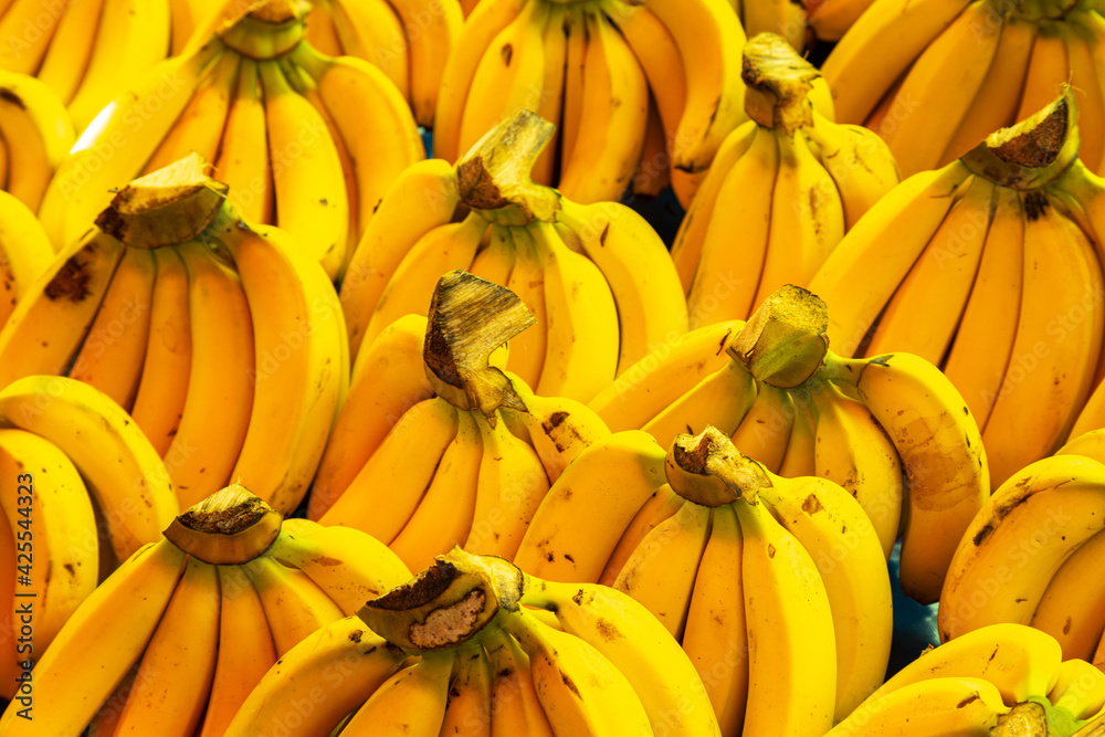 Bananas stacked on a market as a background. Bananas stacked on a market as a background.