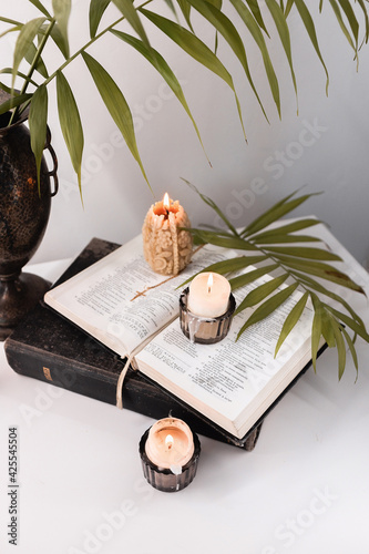 Easter evening with palm leaves, candles and bible next to the icon, Easter theme