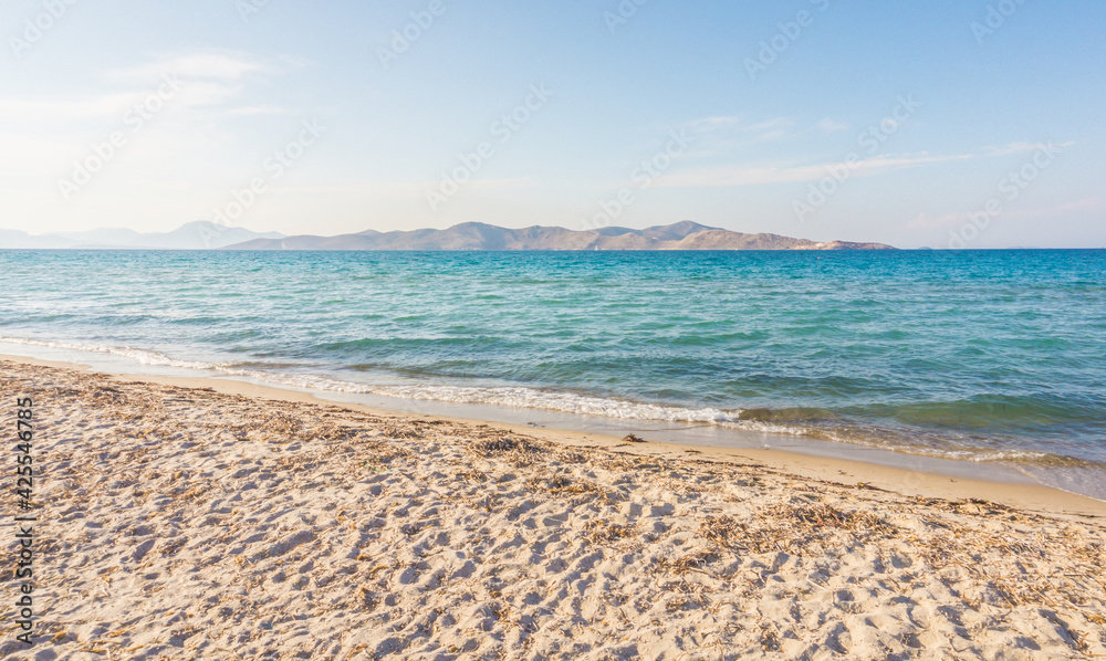 Tigaki beach, Kos, Greece. Beautiful sandy beach with saturated blue water on a sunny day. Dodecanese islands, Aegean Sea