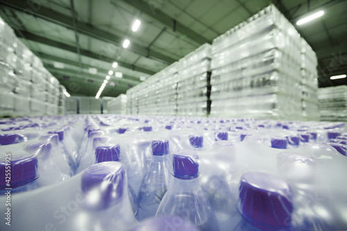 a huge industrial warehouse with plastic food wrap wrapped plastic bottles with carbonated drinks,  water or beer. photo