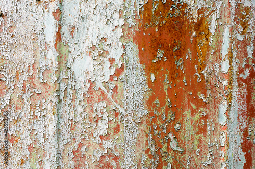 Rusty painted metal texture. Old iron background painted in grey with rust. Weathered metal wall surface with cracked paint.