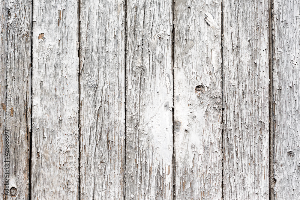 Old painted wooden texture, fence made of wooden planks. Abstract background for design. White rustic fence, peeling paint Old painted wooden texture, fence made of wooden planks. Abstract background for design. White rustic fence, peeling paint