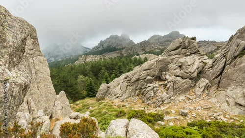 Timelapse view of clouds passing over the rocky top of Monte Limbara in Sardinia, Italy photo