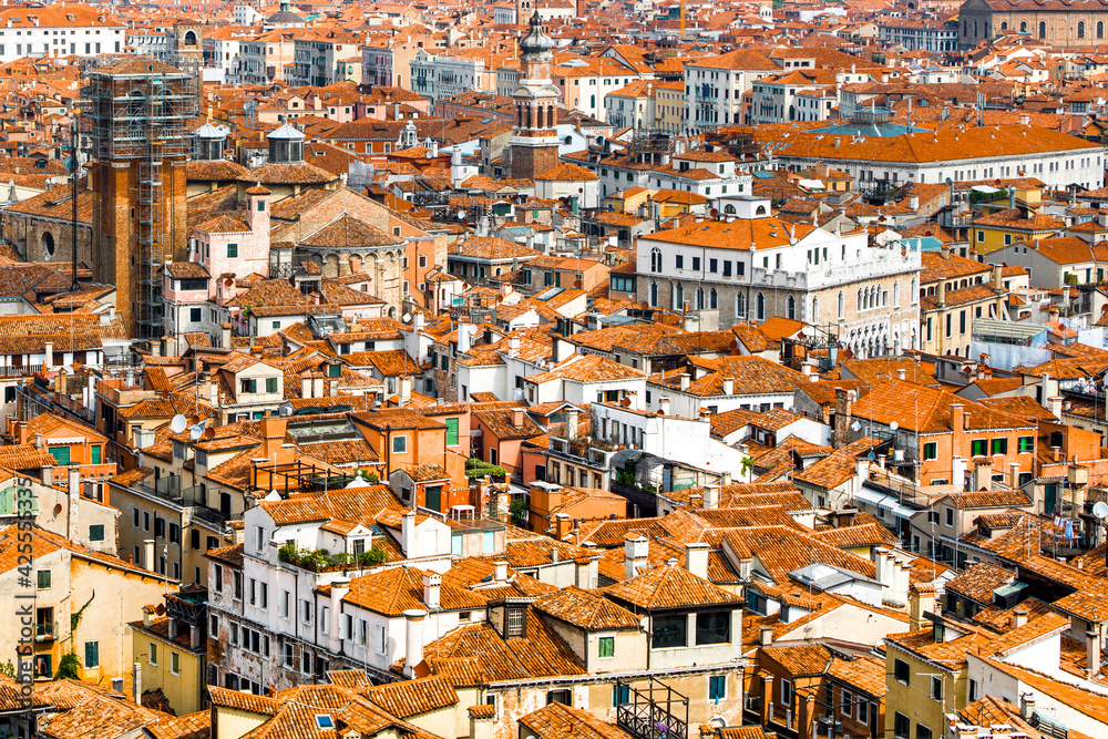 Venice old historical centre with buildings with red tiled roofs, churches and bell tower, Italy