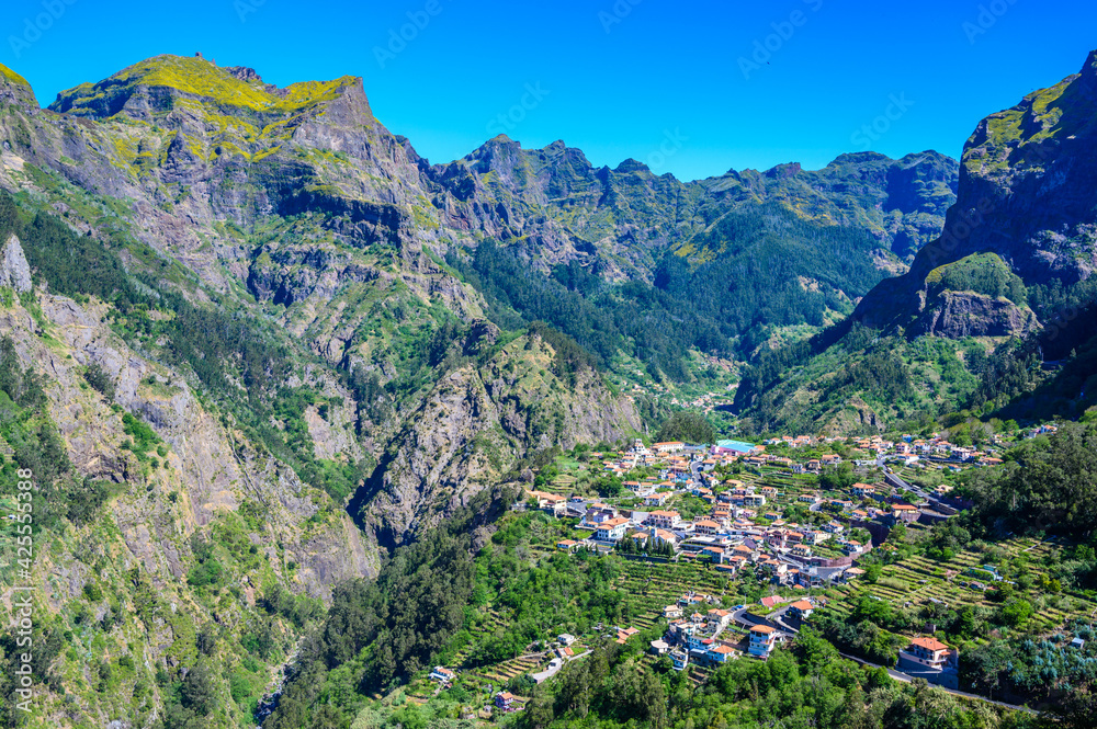 View of Curral das Freiras village in the Nuns Valley in beautiful mountain scenery, municipality of Câmara de Lobos, Madeira island, Portugal. View of Curral das Freiras village in the Nuns Valley in beautiful mountain scenery, municipality of Câmara de Lobos, Madeira island, Portugal.