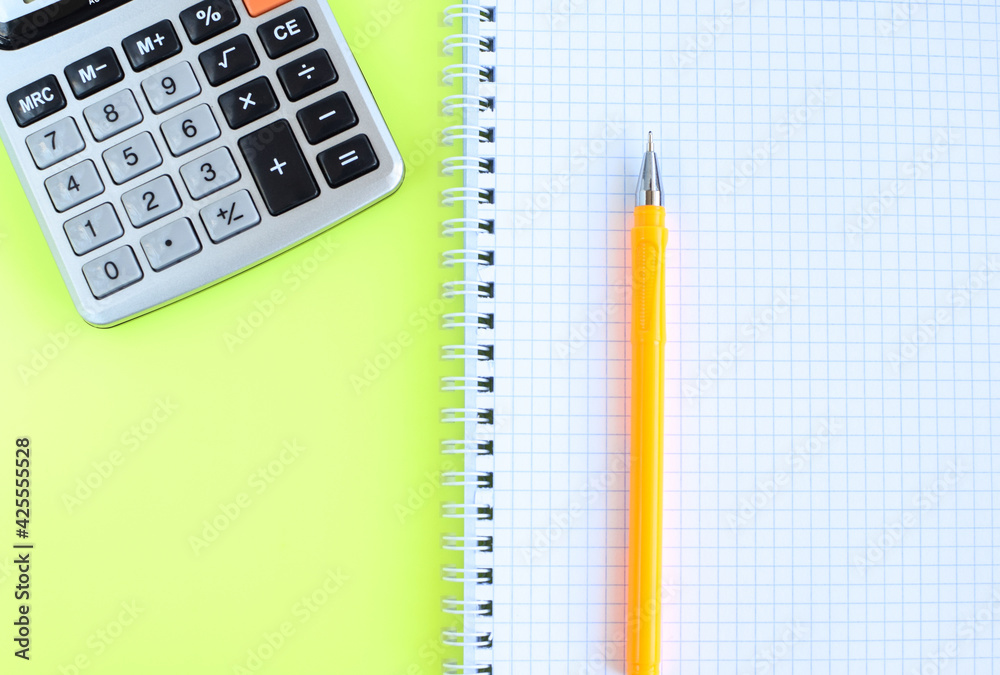 Notebook with pen and calculator. School supplies. Homework for schoolchildren. Copy space for text. Notebook with pen and calculator. School supplies. Homework for schoolchildren. Copy space for text.