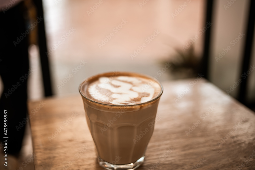 Hot coffee cup of latte art, coffee on wooden table in the morning. Soft focuse Hot coffee cup of latte art, coffee on wooden table in the morning. Soft focuse