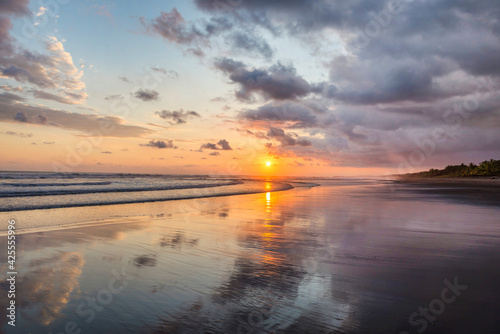 Fototapeta Naklejka Na Ścianę i Meble -  Beautiful sunset sky on the beach in Matapalo, Costa Rica. Central America. Sky background on sunset. Tropical sea.