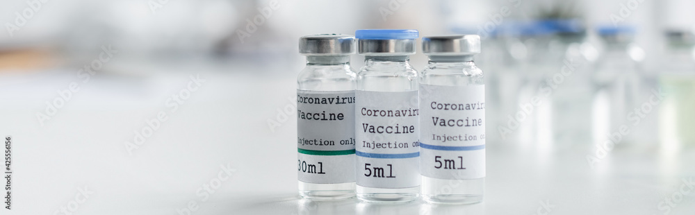 Close up view of jars with coronavirus vaccines in laboratory, banner Close up view of jars with coronavirus vaccines in laboratory, banner
