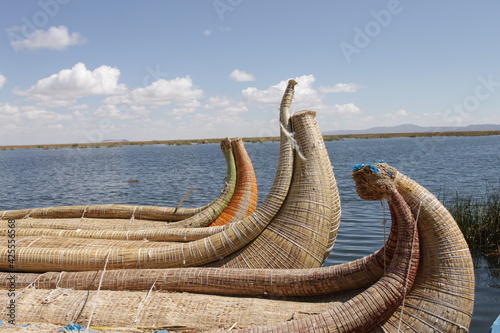 authentic reed boat from titicaca lake in peru and bolivia floating over the water, traditional bonding concept with reed  photo