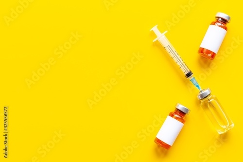 Coronavirus vaccine ampoules with syringe. Vaccination concept
