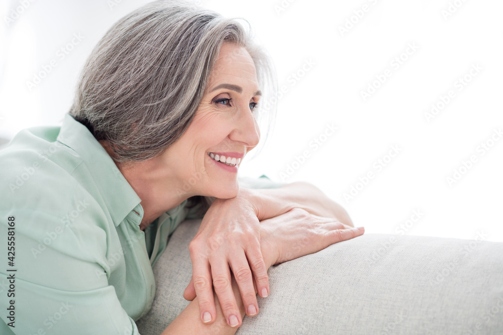 Profile side photo of charming happy positive cheerful old lady look away dream smile indoors inside house Profile side photo of charming happy positive cheerful old lady look away dream smile indoors inside house