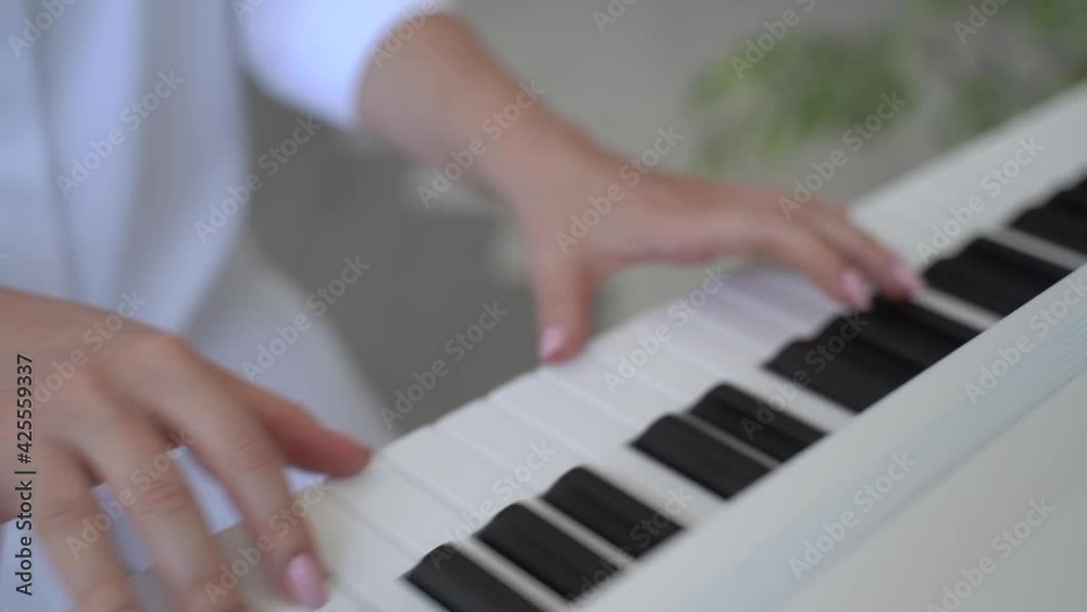 Woman playing the electronic piano Woman playing the electronic piano