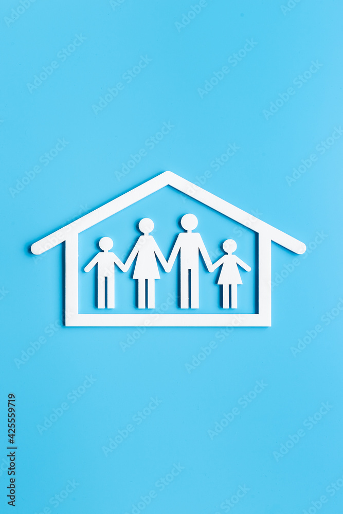 Family at home concept. Wooden family figure in white house. Top view Family at home concept. Wooden family figure in white house. Top view