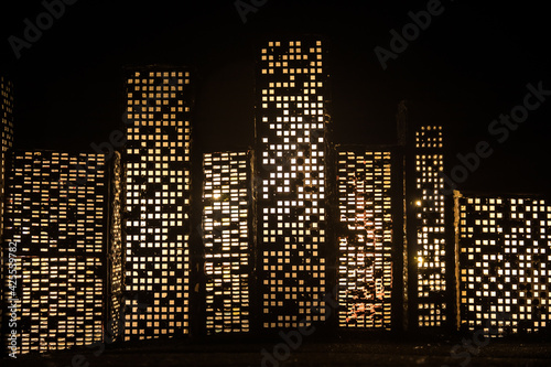 Cartoon style city buildings. Realistic city building miniatures with lights. background.