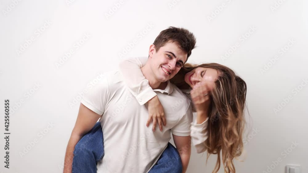 love, passionate and beautiful couple kisses, have fun against the white wall. love, passionate and beautiful couple kisses, have fun against the white wall.