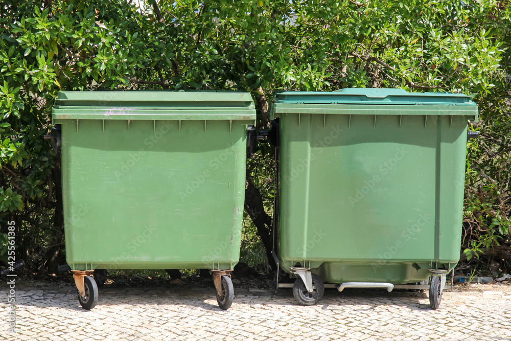 green trash garbage containers on the street green trash garbage containers on the street