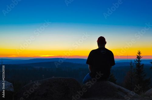 Man watching the sunset in the mountains