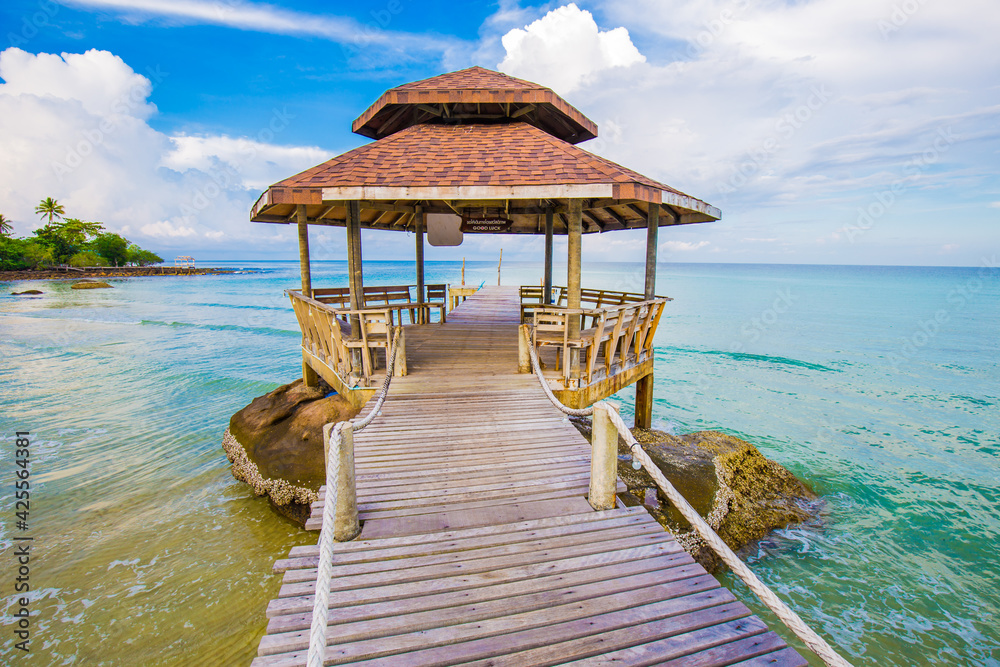 Fototapeta premium Old wood bridge to sea beach with colorful sky cloud