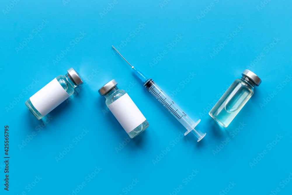 Naklejka premium Coronavirus vaccine ampoules with syringe. Vaccination concept