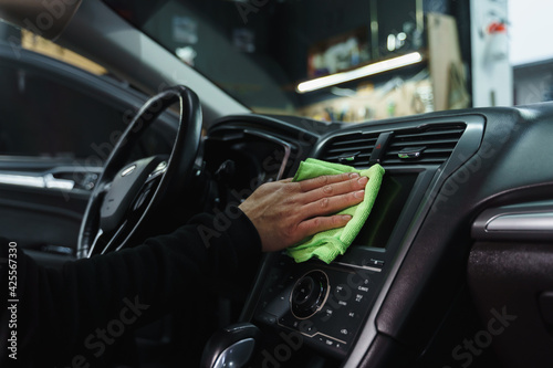 Man cleans interior of car