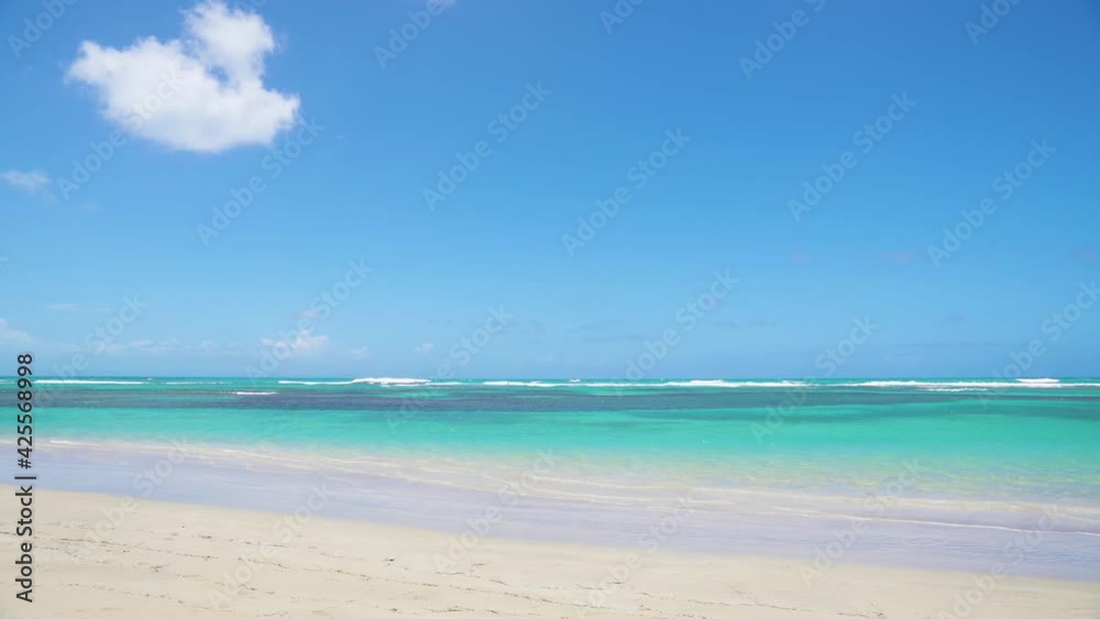 Emerald ocean water with a transparent wave on the white sand of the Maldives beach. Sea voyage on the ocean landscape. Natural background for Valentine's Day. Emerald ocean water with a transparent wave on the white sand of the Maldives beach. Sea voyage on the ocean landscape. Natural background for Valentine's Day.