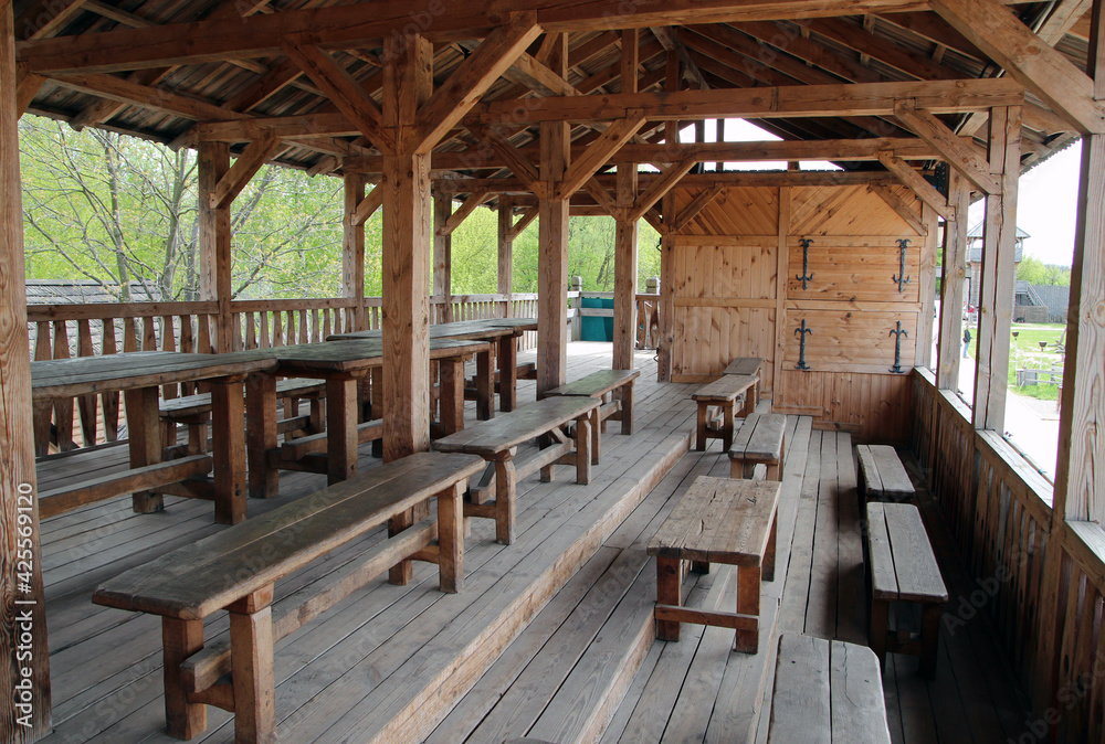 Empty vintage wooden restaurant tables and benches outdoor during the coronavirus covid threat