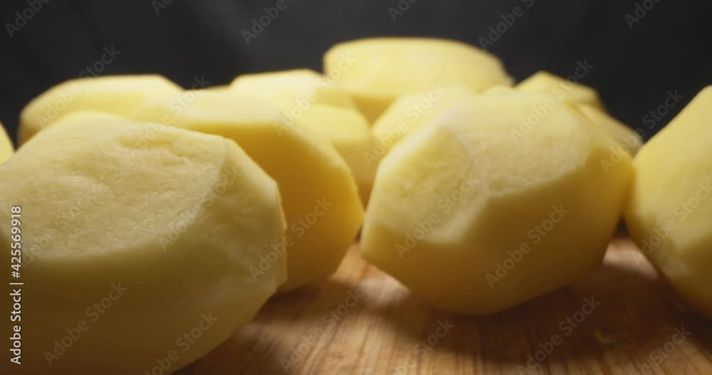 detailed extreme close-up of peeled potatoes on wooden board. detailed extreme close-up of peeled potatoes on wooden board.