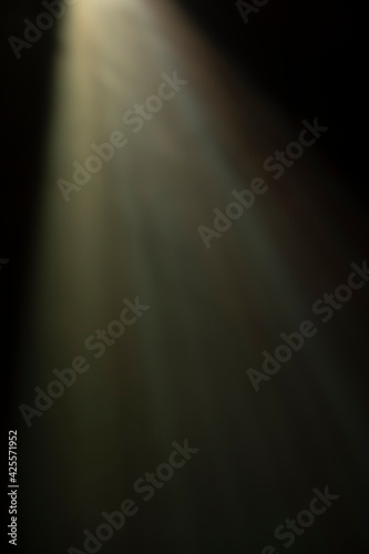 
flare of light on a black background. abstract spotlight background