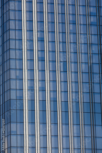 A modern skyscraper for office work. Glass surface of windows, a large amount of light,