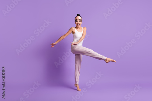 Full length body size photo of girl doing stretching exercises in the morning isolated pastel purple color background © deagreez